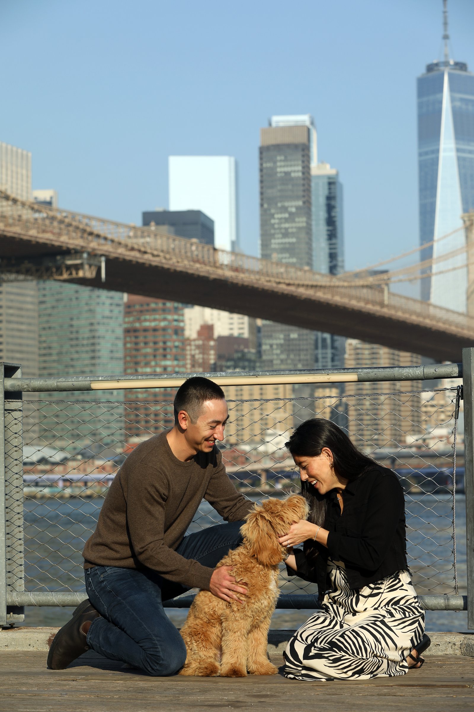 Couple beneath a city bridge photographed by Corey Fader